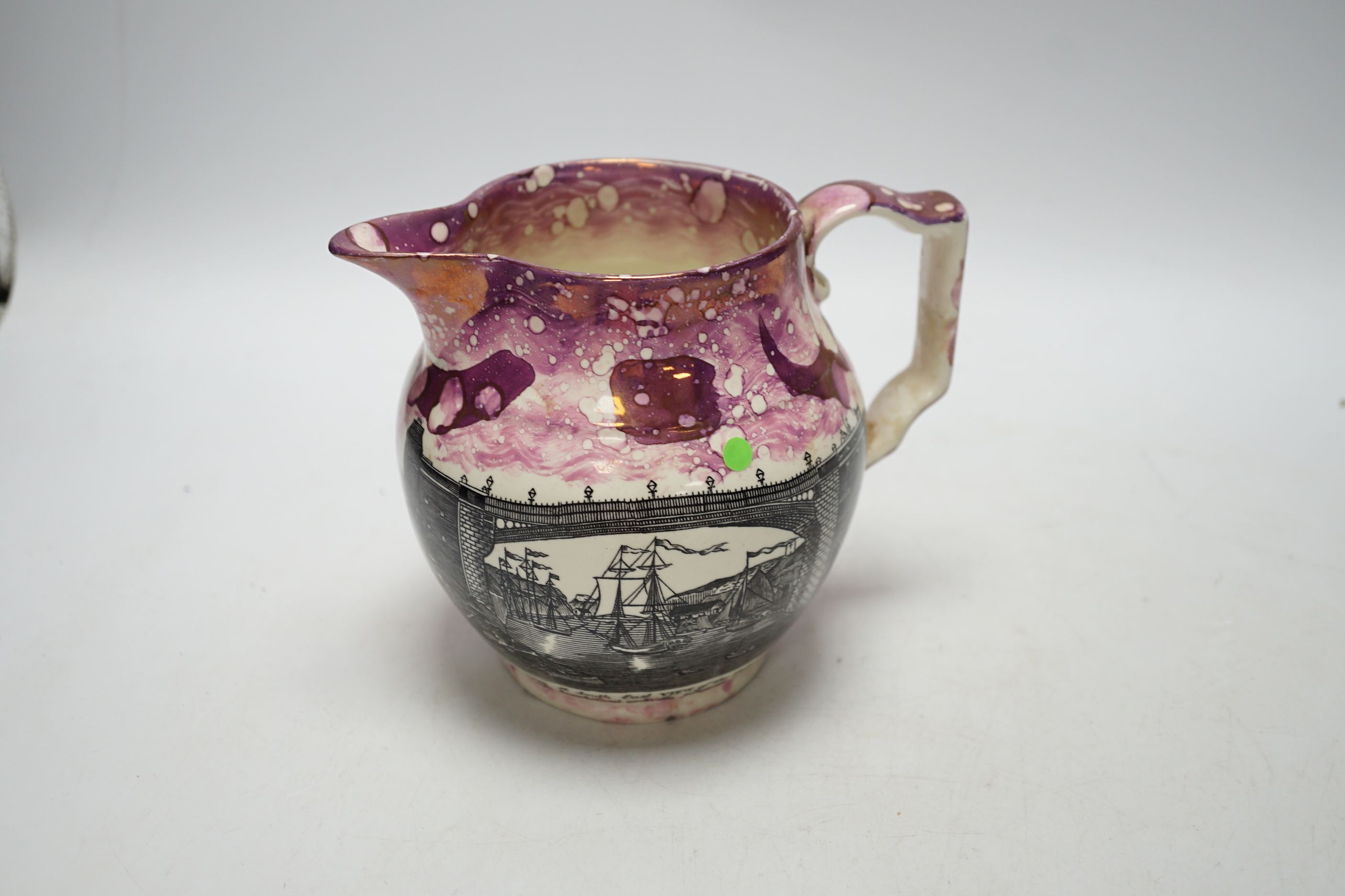 A Worcester Kakiemon pattern coffee cup and saucer, c.1780 and Gray’s Pottery pink lustre ‘’Iron Bridge Sunderland’’ jug, (3), 13cm